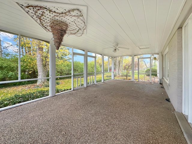 unfurnished sunroom with ceiling fan and a healthy amount of sunlight