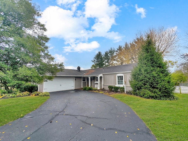 single story home featuring a front yard and a garage