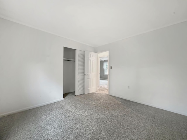 unfurnished bedroom featuring carpet and a closet