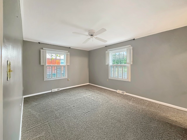 carpeted spare room featuring ceiling fan