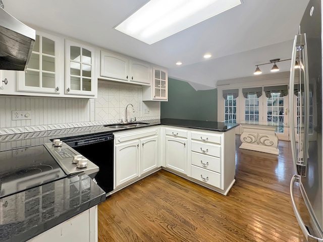 kitchen with white cabinets, wood-type flooring, and sink