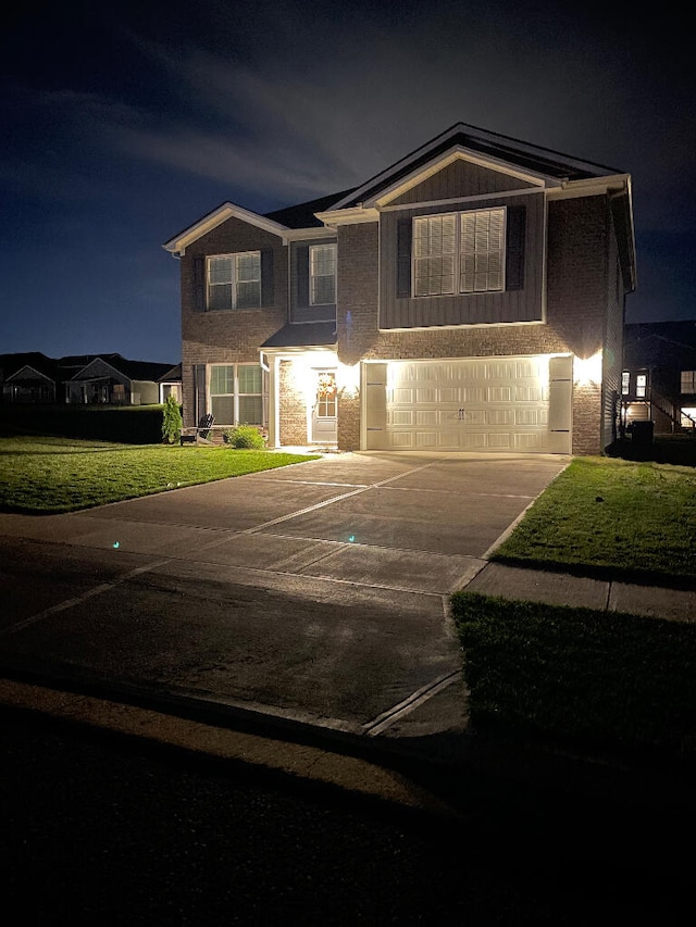 view of front of property featuring a yard and a garage