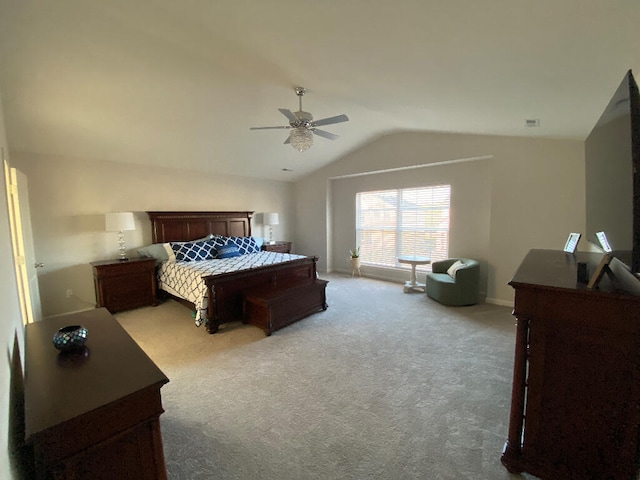 carpeted bedroom with vaulted ceiling and ceiling fan