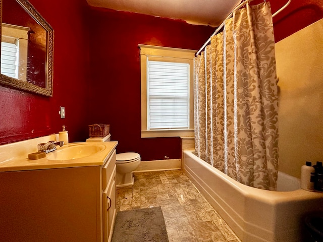 bathroom featuring vanity, toilet, and curtained shower