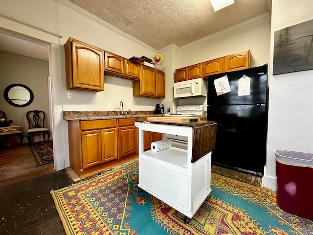 kitchen with a textured ceiling, black refrigerator, dark hardwood / wood-style floors, and ornamental molding