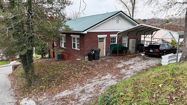 view of front of home featuring a carport and cooling unit