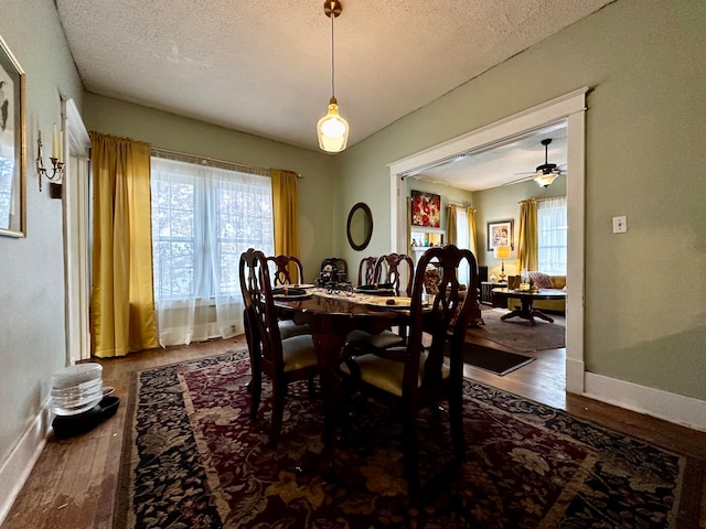 dining area featuring ceiling fan, hardwood / wood-style floors, and a textured ceiling