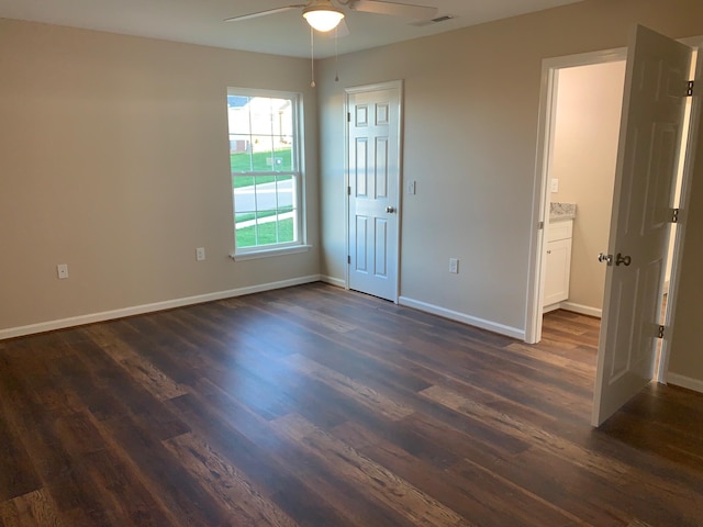 empty room with ceiling fan and dark wood-type flooring