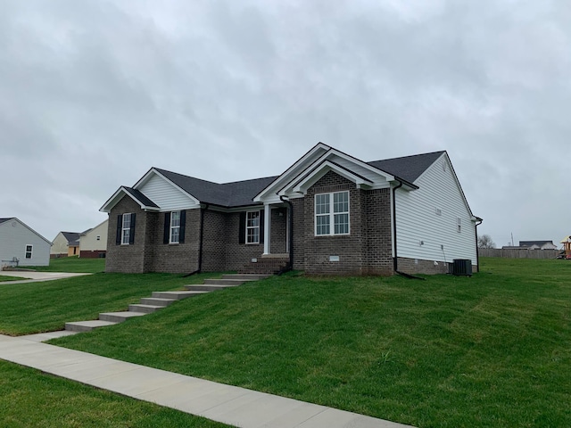 view of front of house featuring a front yard and central AC