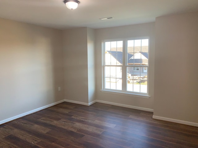 unfurnished room featuring dark wood-type flooring