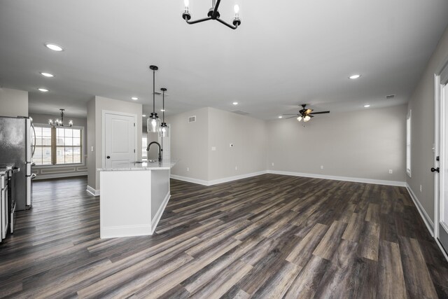 interior space featuring sink, ceiling fan with notable chandelier, and dark hardwood / wood-style floors