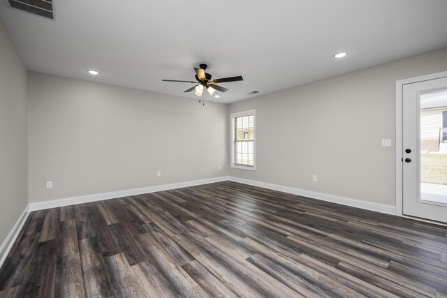 spare room with dark hardwood / wood-style floors and ceiling fan