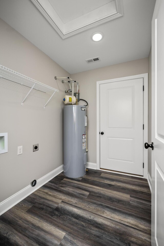 clothes washing area featuring dark wood-type flooring, water heater, and electric dryer hookup