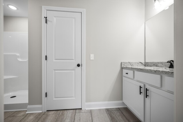 bathroom featuring vanity and walk in shower