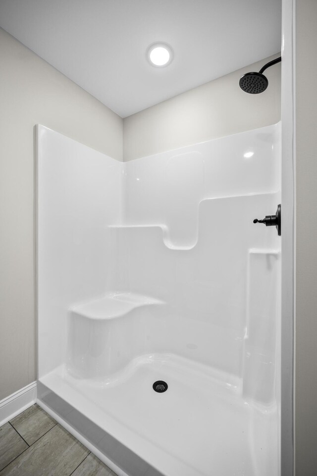 bathroom featuring hardwood / wood-style floors and a shower