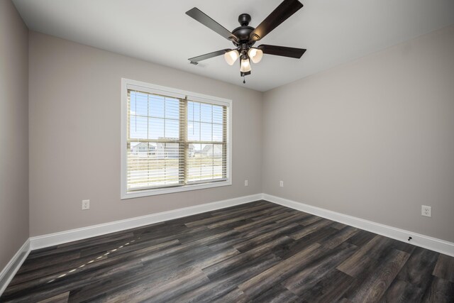 unfurnished room featuring dark wood-type flooring and ceiling fan