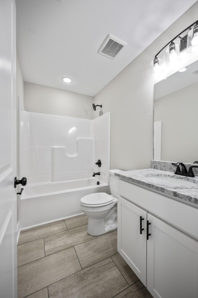 full bathroom with vanity, shower / washtub combination, and toilet