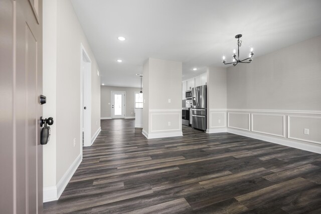 interior space featuring a notable chandelier and dark wood-type flooring