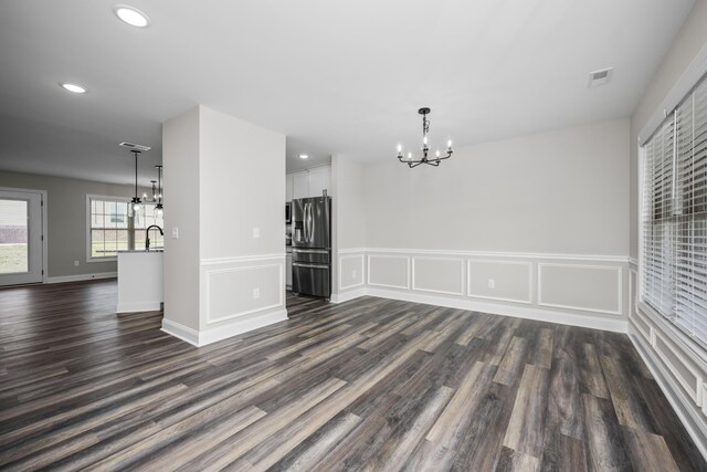 interior space with dark hardwood / wood-style floors, sink, and an inviting chandelier