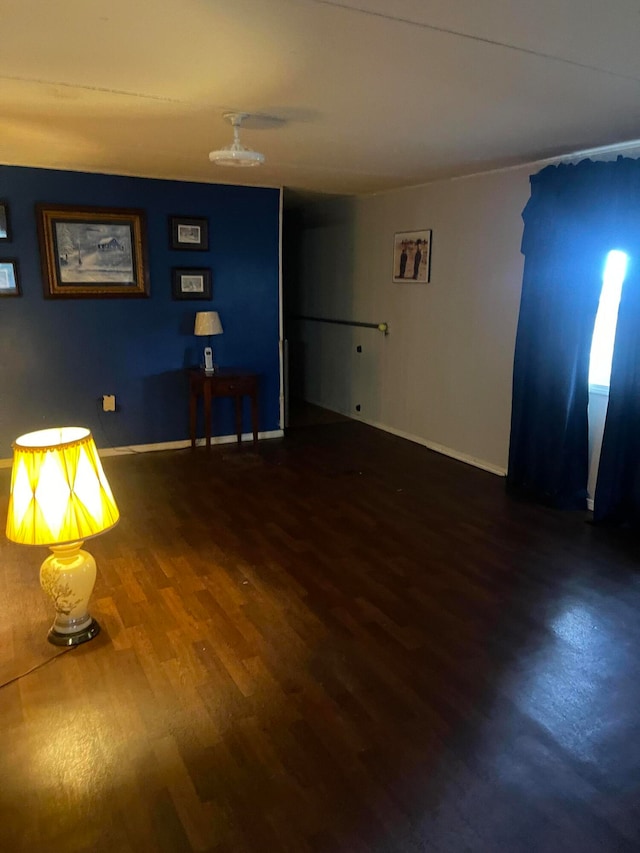 empty room with dark hardwood / wood-style flooring