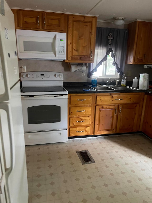 kitchen with white appliances and sink