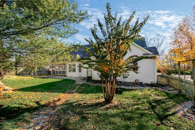 view of property exterior with a yard