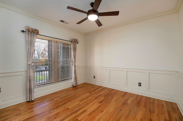 unfurnished room featuring light hardwood / wood-style flooring, ceiling fan, and ornamental molding