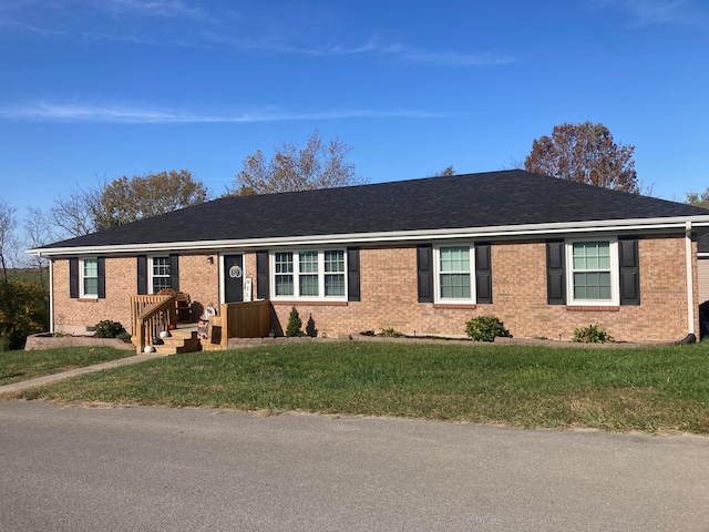 single story home featuring a front lawn