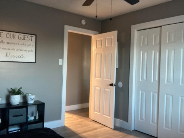 bedroom with hardwood / wood-style flooring, a closet, and ceiling fan