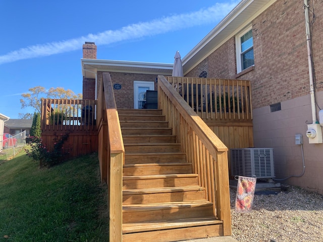 rear view of house with a lawn and a deck