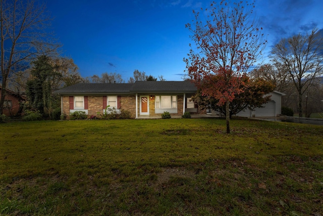 single story home featuring a garage and a front lawn