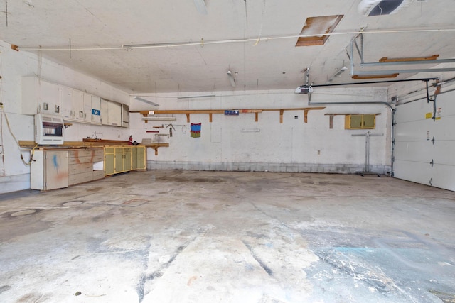 garage featuring a workshop area, heating unit, and a garage door opener