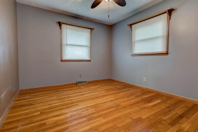 unfurnished room with ceiling fan and light wood-type flooring