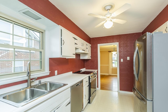 kitchen featuring white cabinetry, appliances with stainless steel finishes, sink, and plenty of natural light