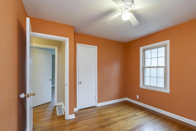 unfurnished bedroom featuring ceiling fan and light wood-type flooring