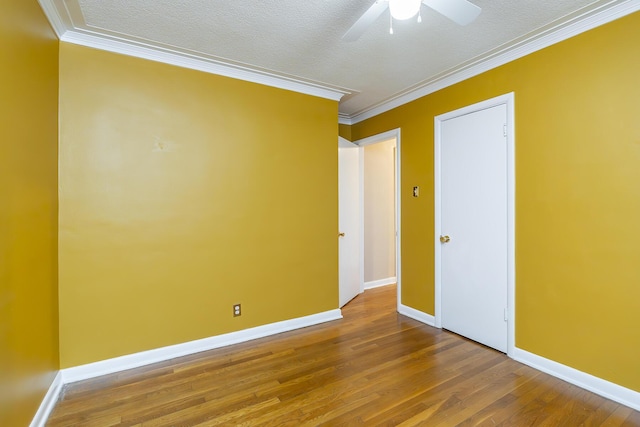 unfurnished room with crown molding, ceiling fan, hardwood / wood-style flooring, and a textured ceiling