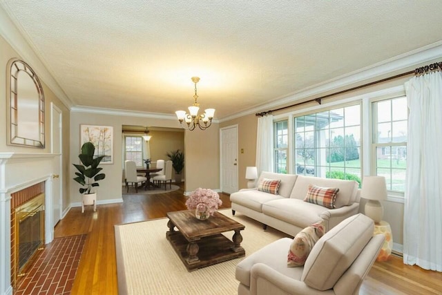 living room with crown molding, hardwood / wood-style flooring, a chandelier, and a textured ceiling