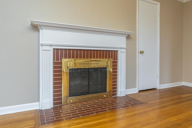 room details featuring a brick fireplace and hardwood / wood-style floors