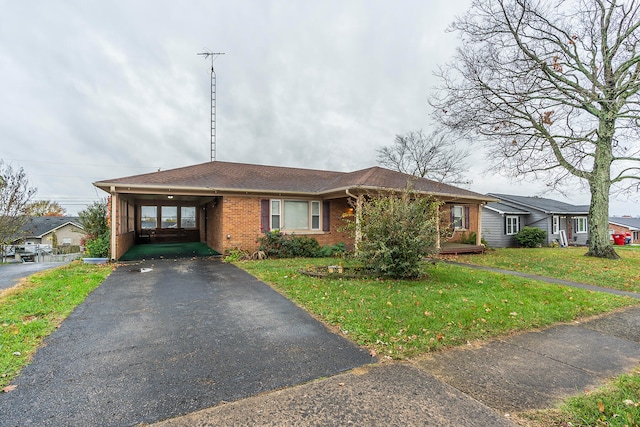 ranch-style home with a carport and a front yard