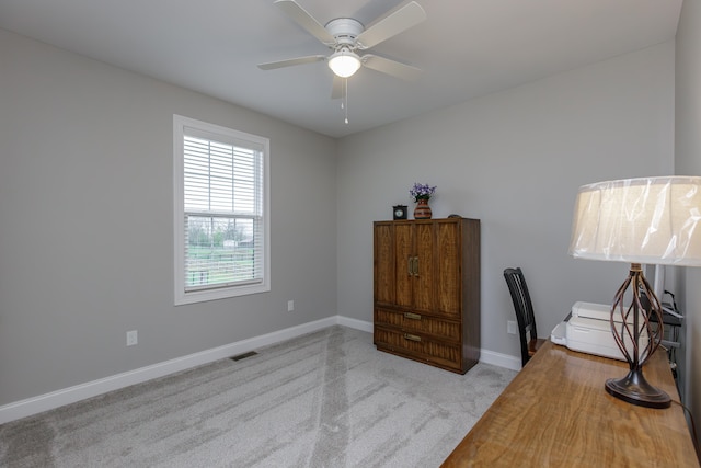 home office featuring light colored carpet and ceiling fan