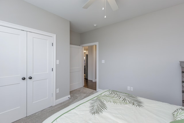 bedroom with ceiling fan, a closet, and light colored carpet