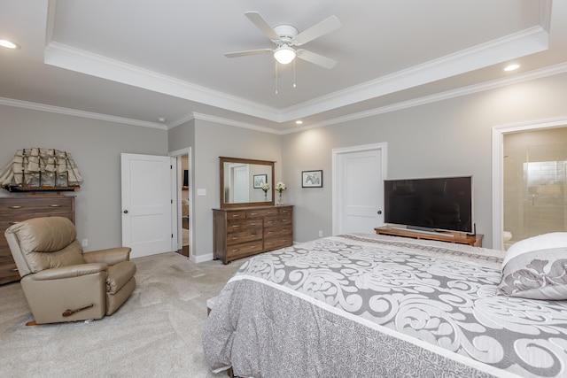 carpeted bedroom featuring ceiling fan, ornamental molding, connected bathroom, and a tray ceiling