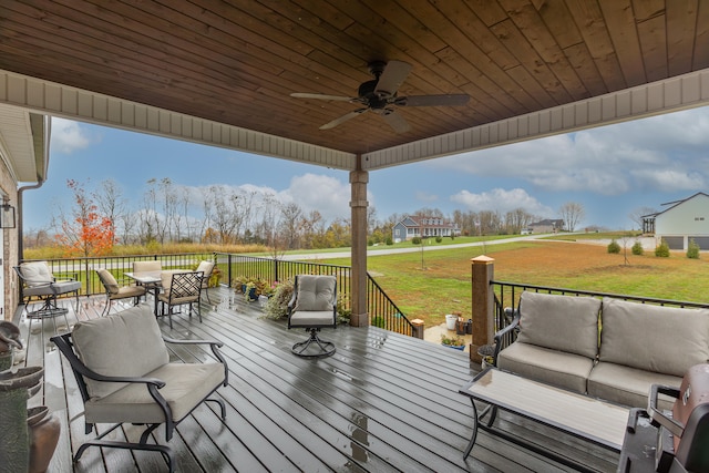 wooden terrace featuring an outdoor living space, a yard, and ceiling fan