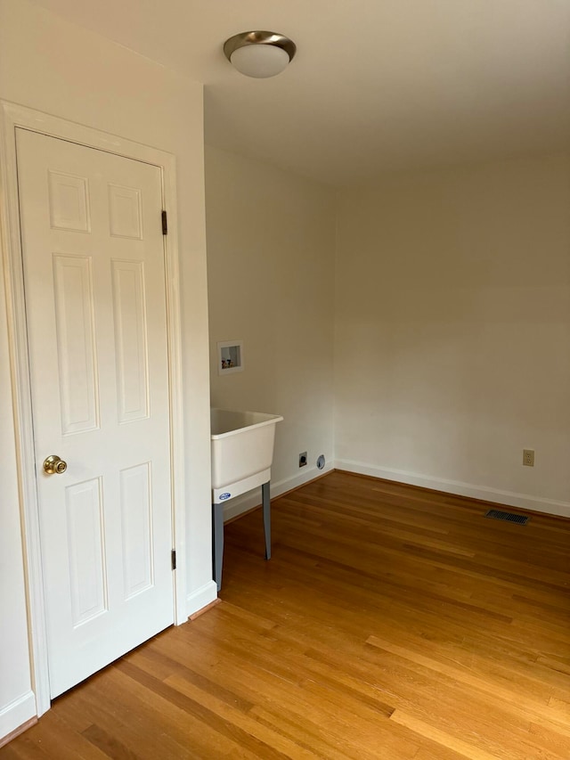 laundry room with hardwood / wood-style floors and hookup for a washing machine