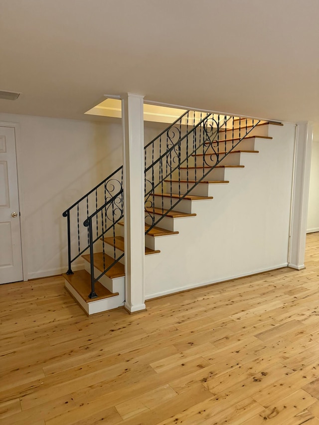 stairway featuring hardwood / wood-style floors