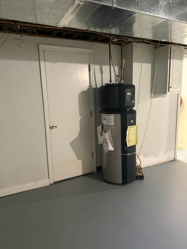 utility room featuring hybrid water heater