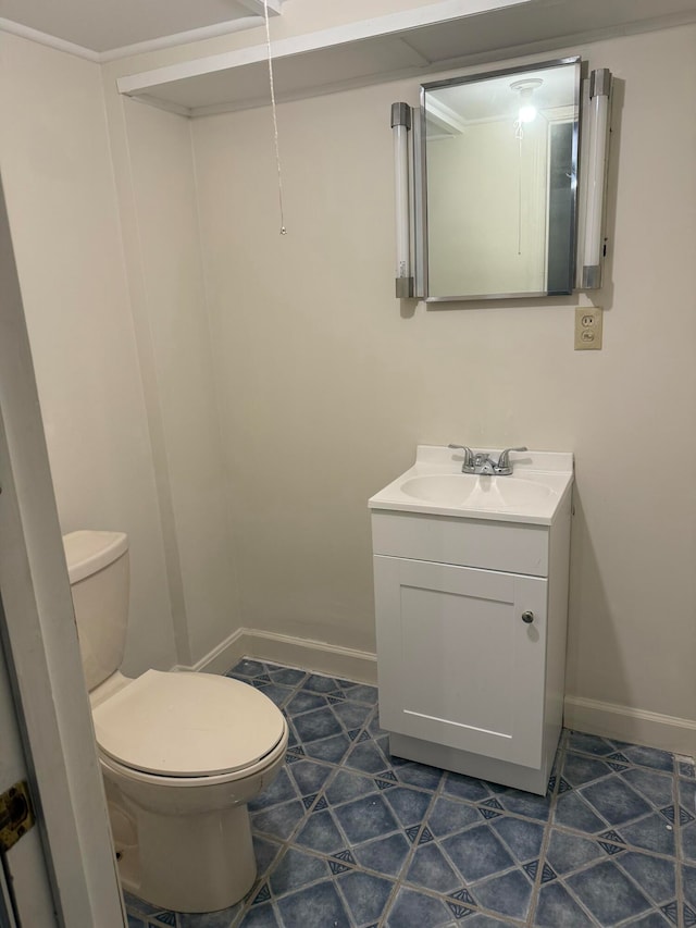 bathroom with tile patterned floors, vanity, and toilet