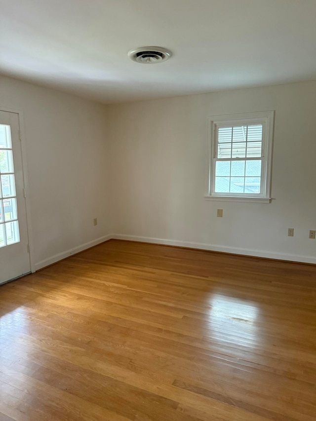 empty room featuring light hardwood / wood-style flooring and a wealth of natural light