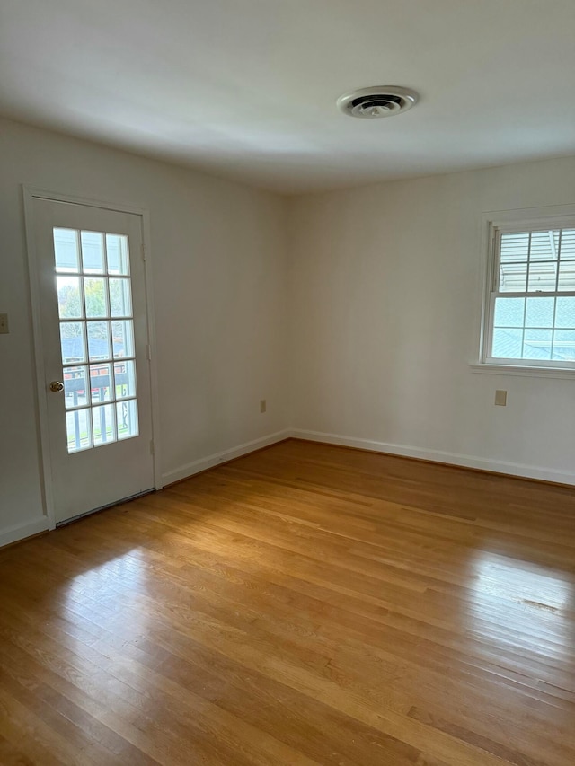 empty room with light hardwood / wood-style flooring