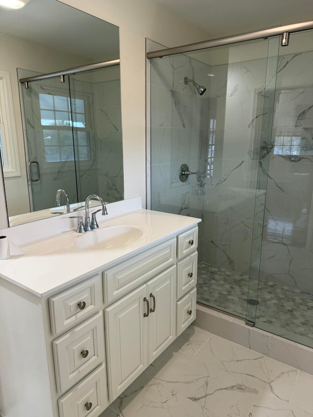 bathroom with vanity and a shower with shower door